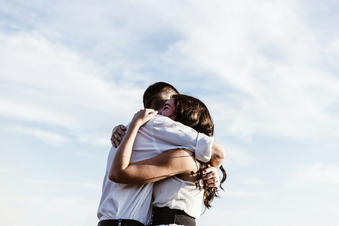 One friend comforting another with a hug