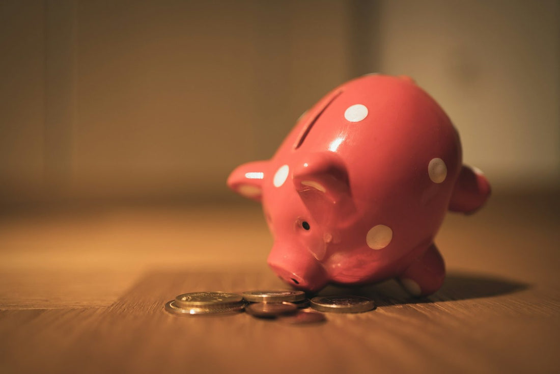 A child putting a coin into a piggy bank