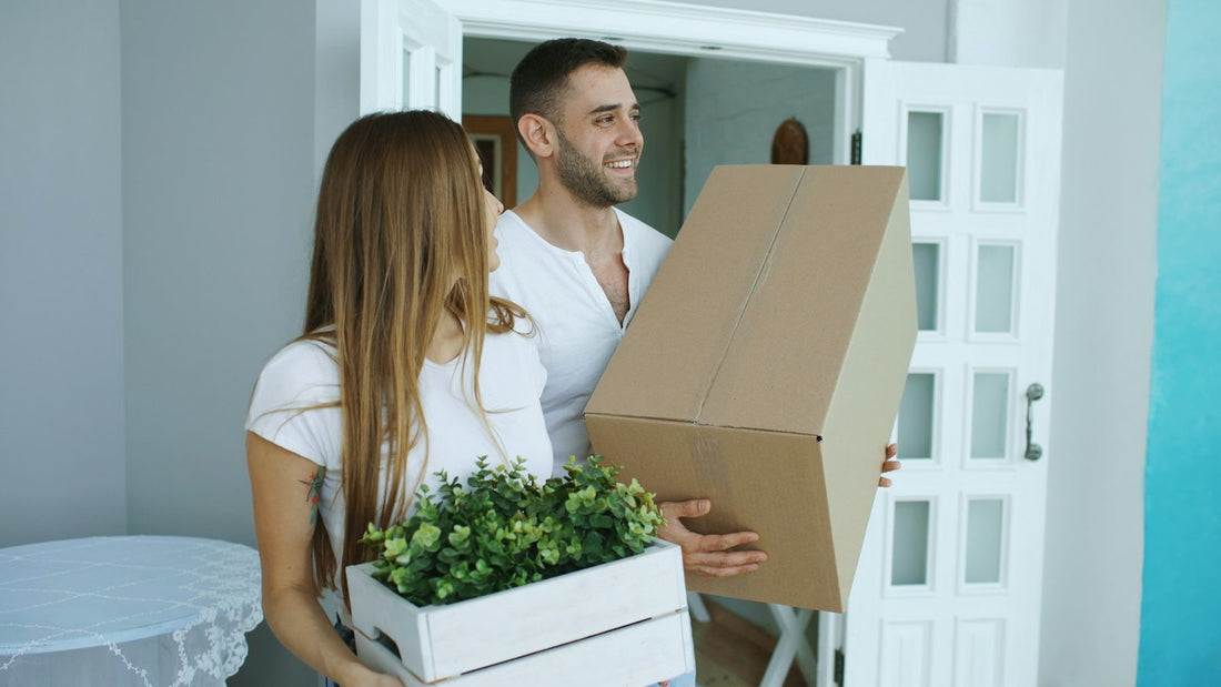 A young couple at the door of their new house